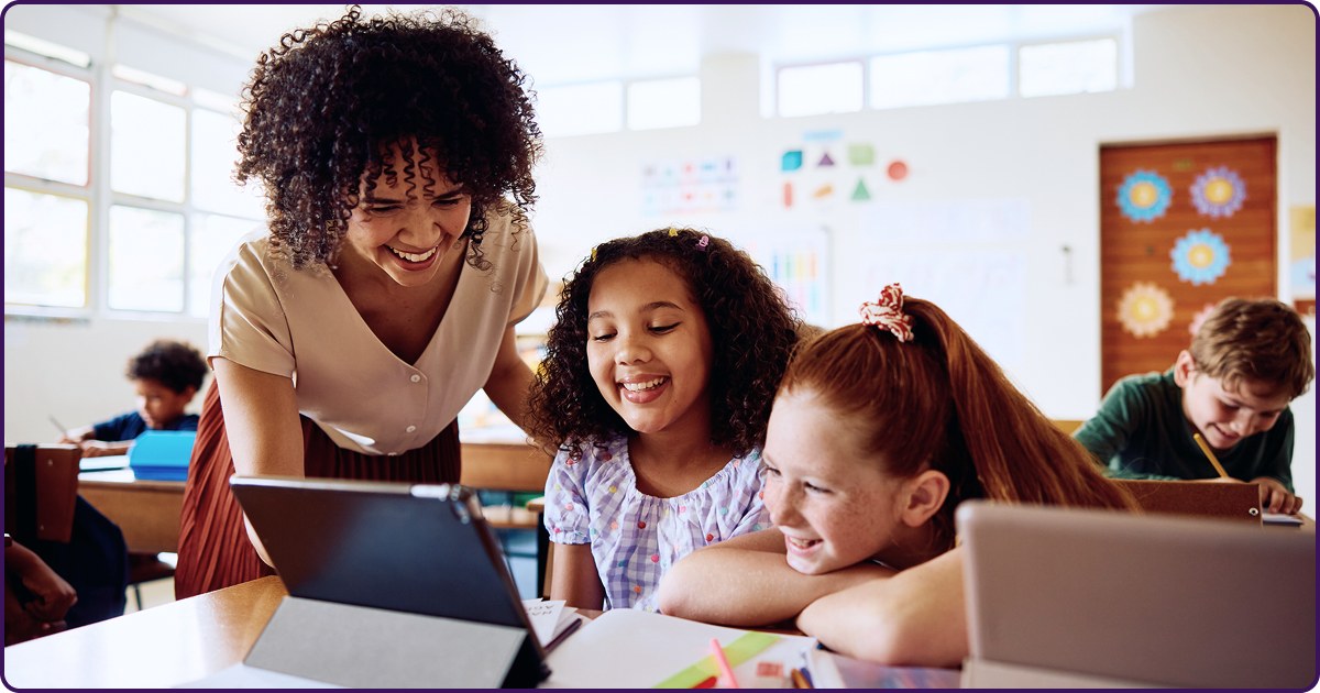 Teacher working with 2 students in classroom